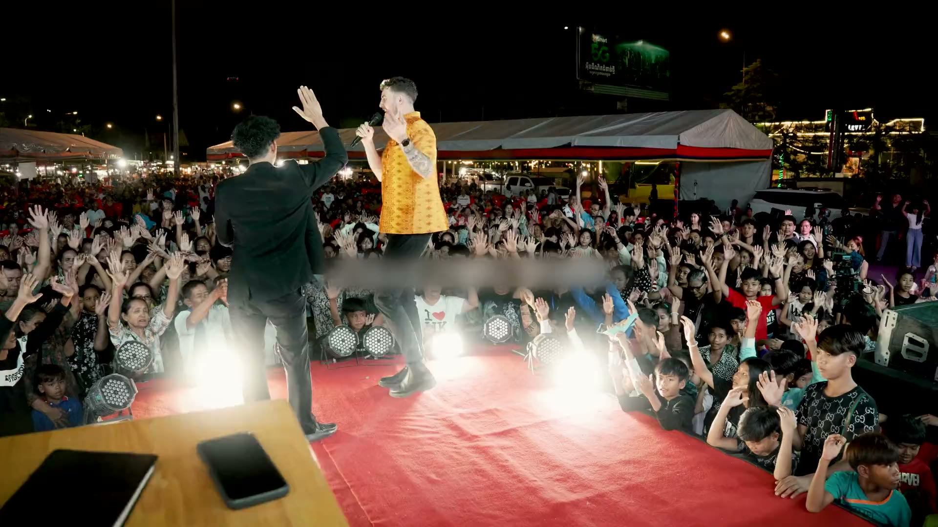 Chris preaching to a packed crusade crowd at night in Kandal, Cambodia
