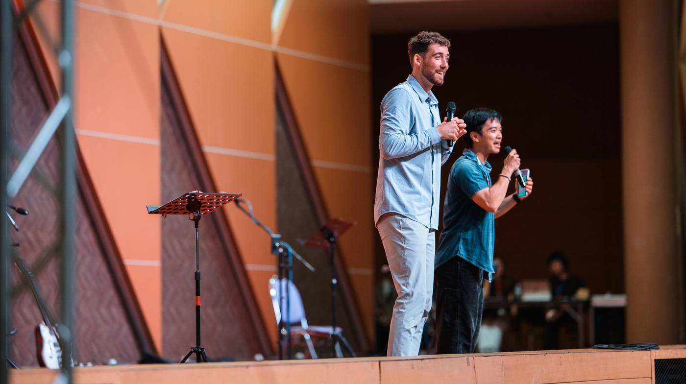 Chris preaching on stage with his interpreter